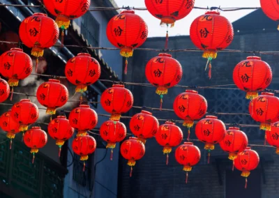 Grid of red Jiufen lanterns filling the entire frame with Chinese characters and golden tassels