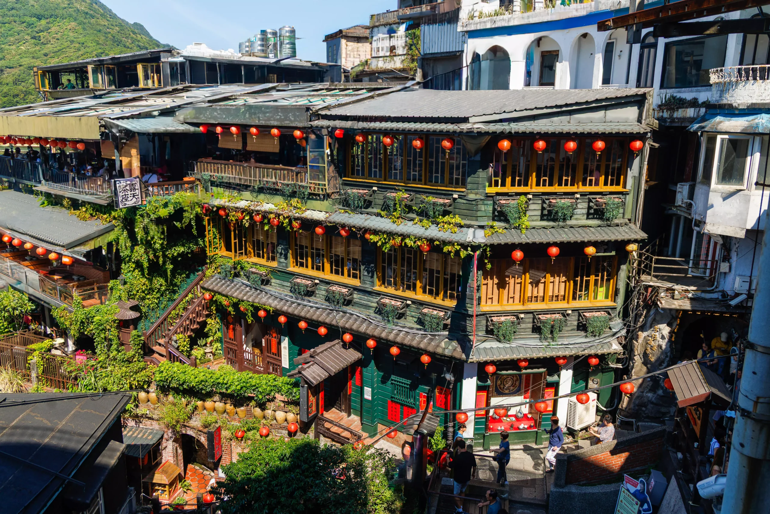 longshan-temple-taipei-facade-blue-sky Ornate facade of Longshan Temple Taipei with colourful dragons and tiled rooftop against blue sky