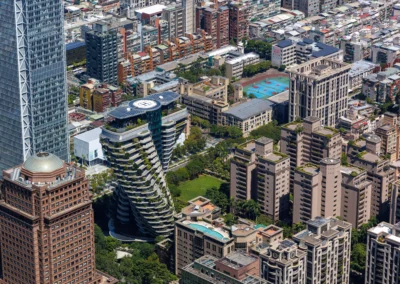 Aerial close-up of the Agora Garden twin towers with their spiral planted terraces seen from Taipei 101