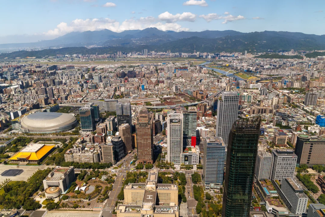 Aerial view of Taipei from Taipei 101 showing the Taipei Dome stadium, National Concert Hall golden roof and Tamsui River