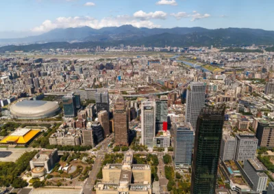Aerial view of Taipei from Taipei 101 showing the Taipei Dome stadium, National Concert Hall golden roof and Tamsui River