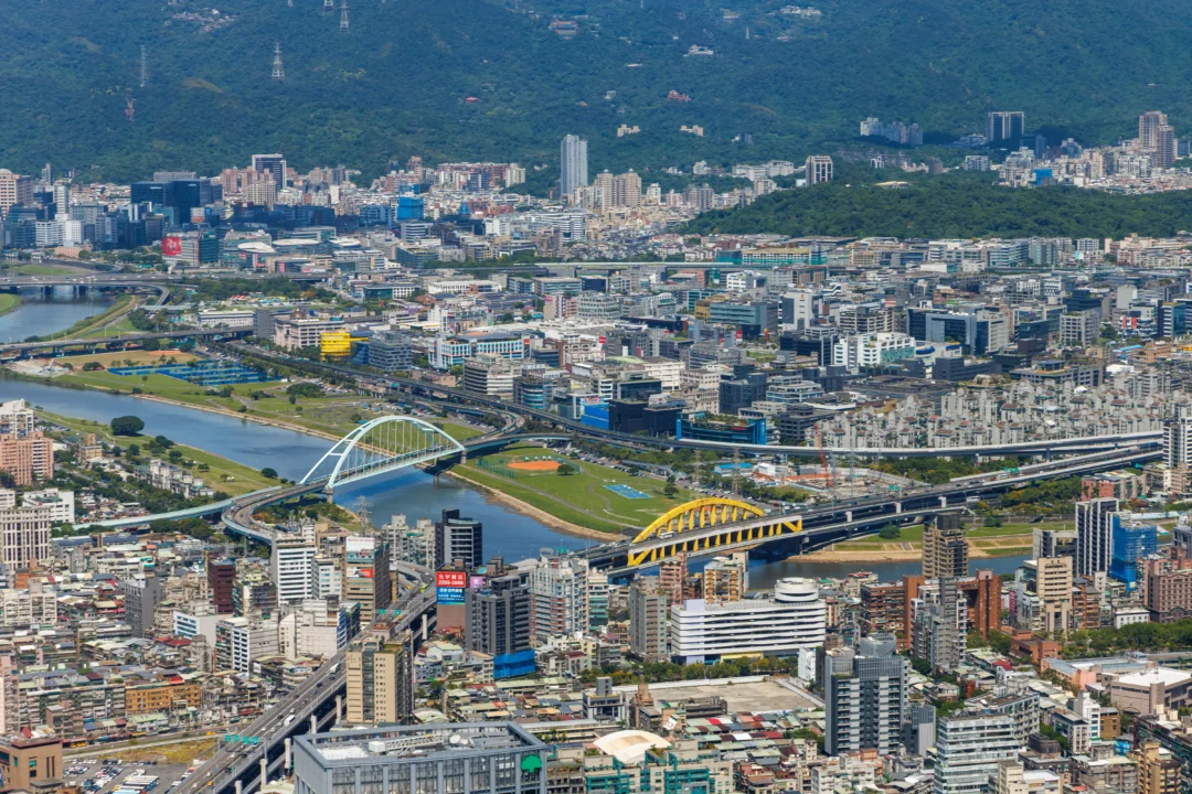 Aerial view of Taipei's rivers and coloured arch bridges from Taipei 101