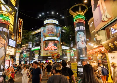 Ximending at night from a slightly wider angle showing the neon-lit junction and busy street below