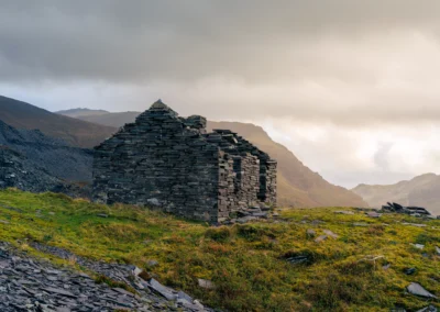 An abandoned, roofless stone building made of stacked slate at Dinorwig Quarry.
