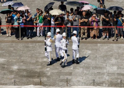 Four military honour guards in white uniforms marching during the changing of the guard ceremony at Chiang Kai-shek Memorial Hall, Taipei