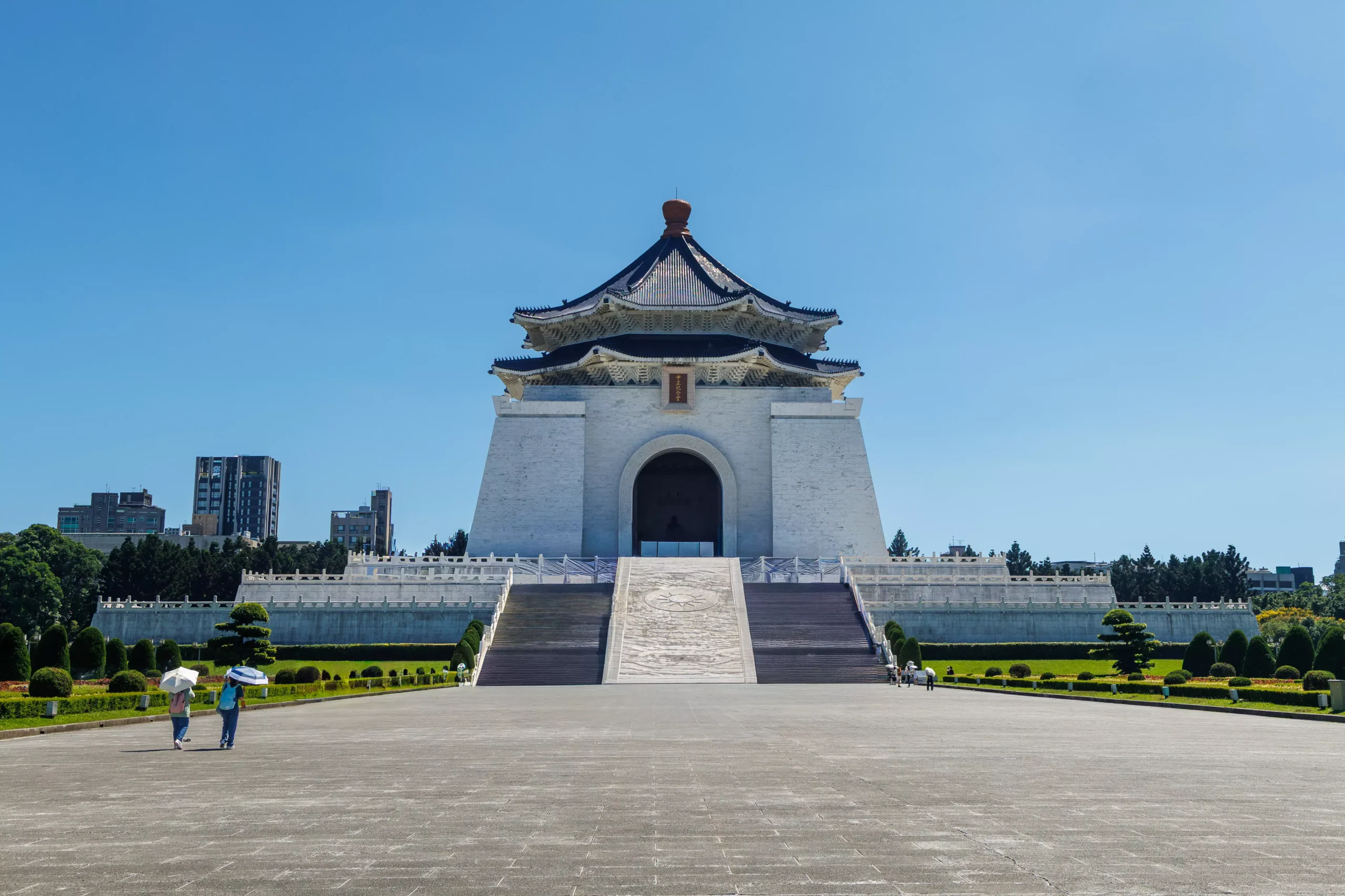 longshan-temple-taipei-facade-blue-sky Ornate facade of Longshan Temple Taipei with colourful dragons and tiled rooftop against blue sky