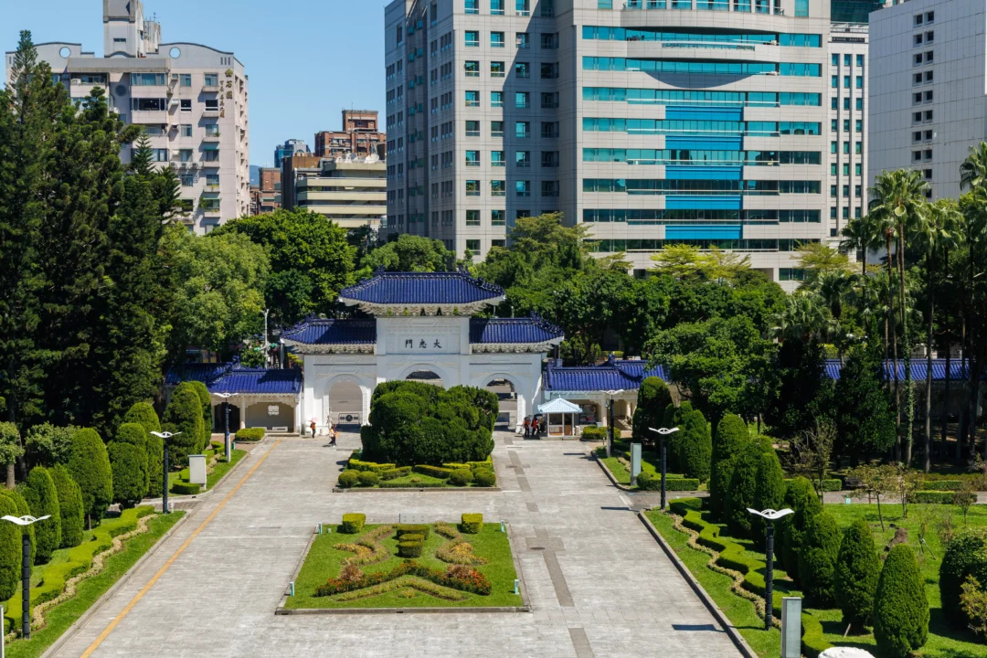 View from the memorial hall terrace down the formal gardens towards the Zhongzheng Gate with Taipei buildings behind