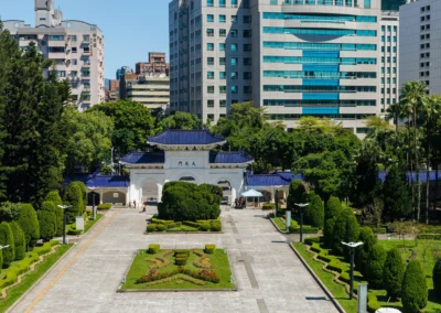 View from the memorial hall terrace down the formal gardens toward the Zhongzheng Gate with Taipei buildings behind