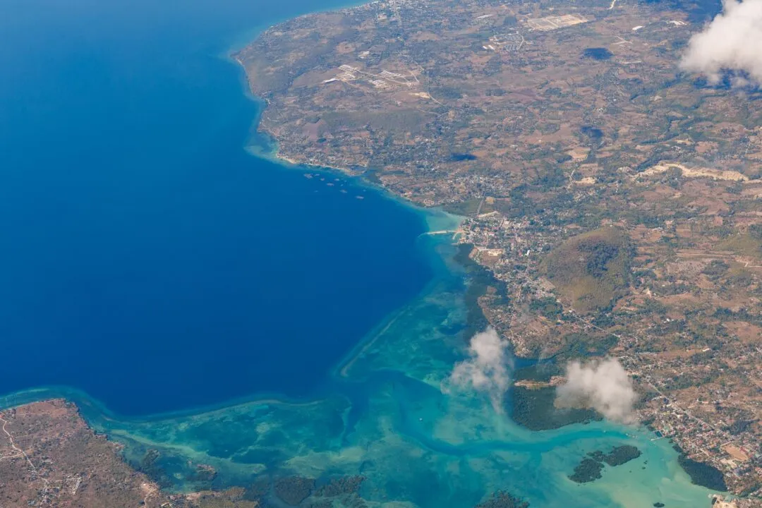 Aerial coastline reef deep blue bay El Nido