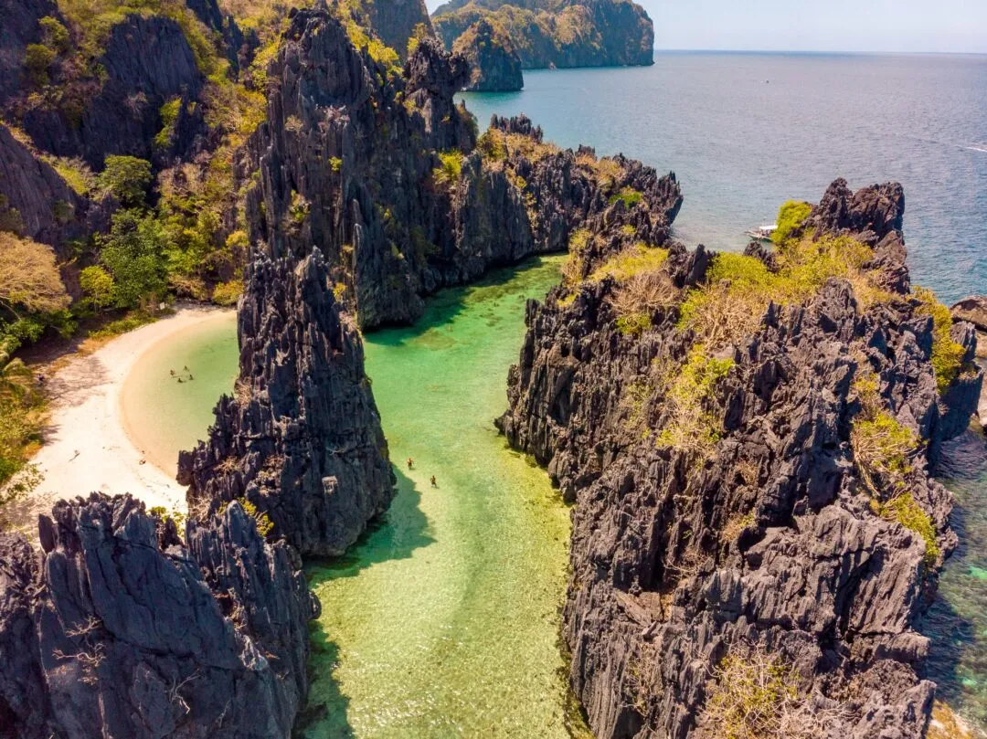 Aerial hidden lagoon karst spires turquoise El Nido