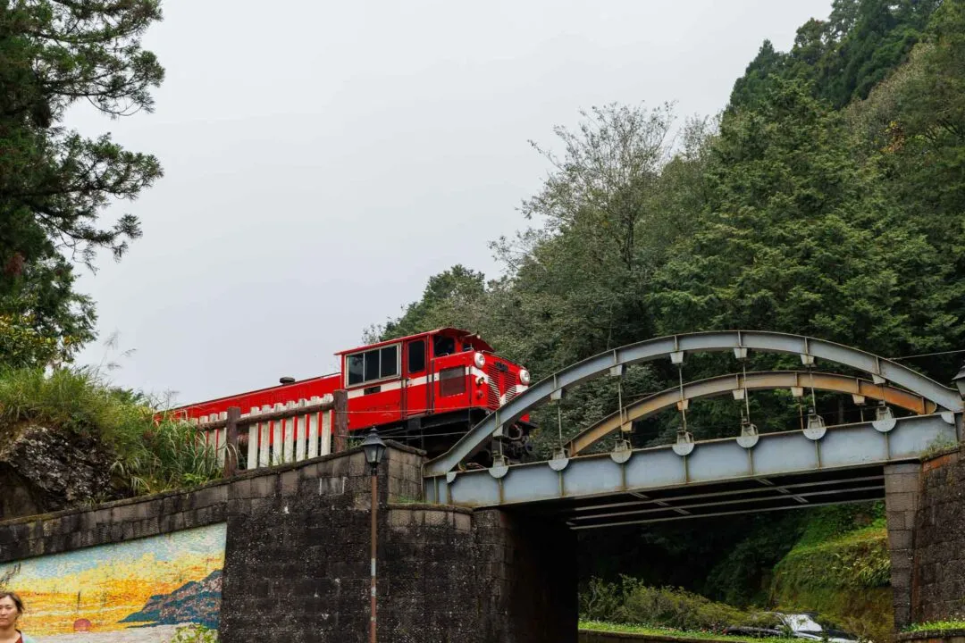 Red Alishan Forest Railway train crossing an arch bridge, Taiwan