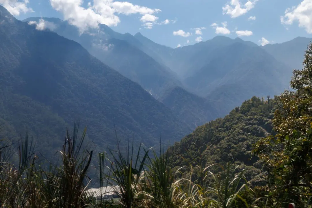 Layered mountain valley with sunbeams cutting through haze, Alishan, Taiwan