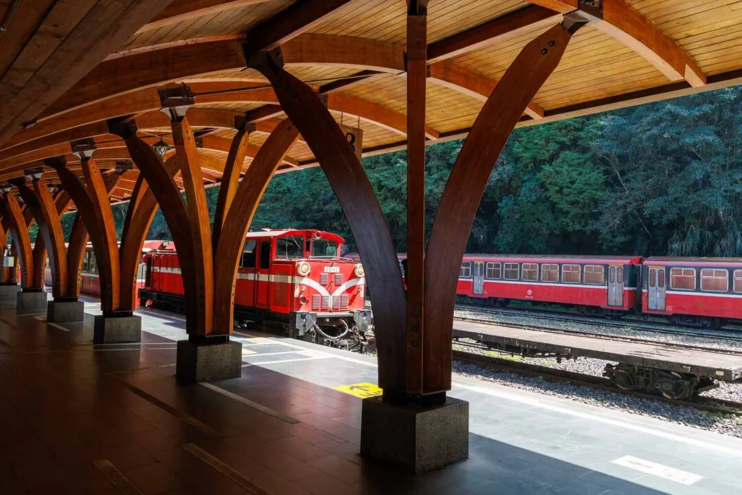 Striking wooden arched station roof framing the red Alishan train, Taiwan