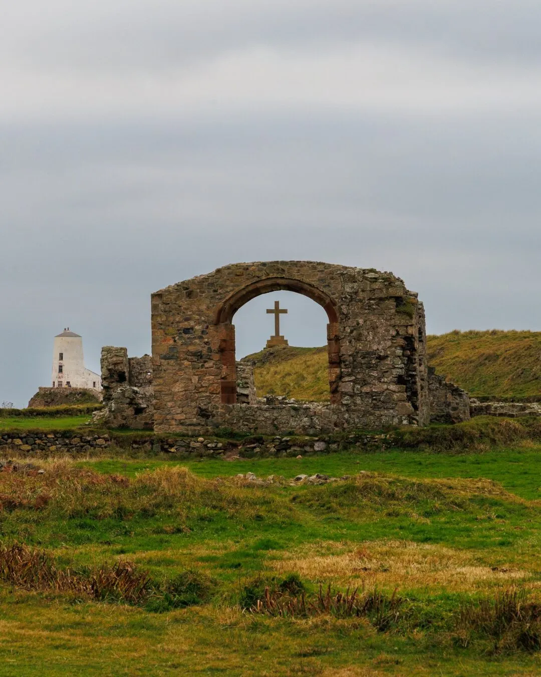 Anglesey llanddwyn lighthouse through ruins