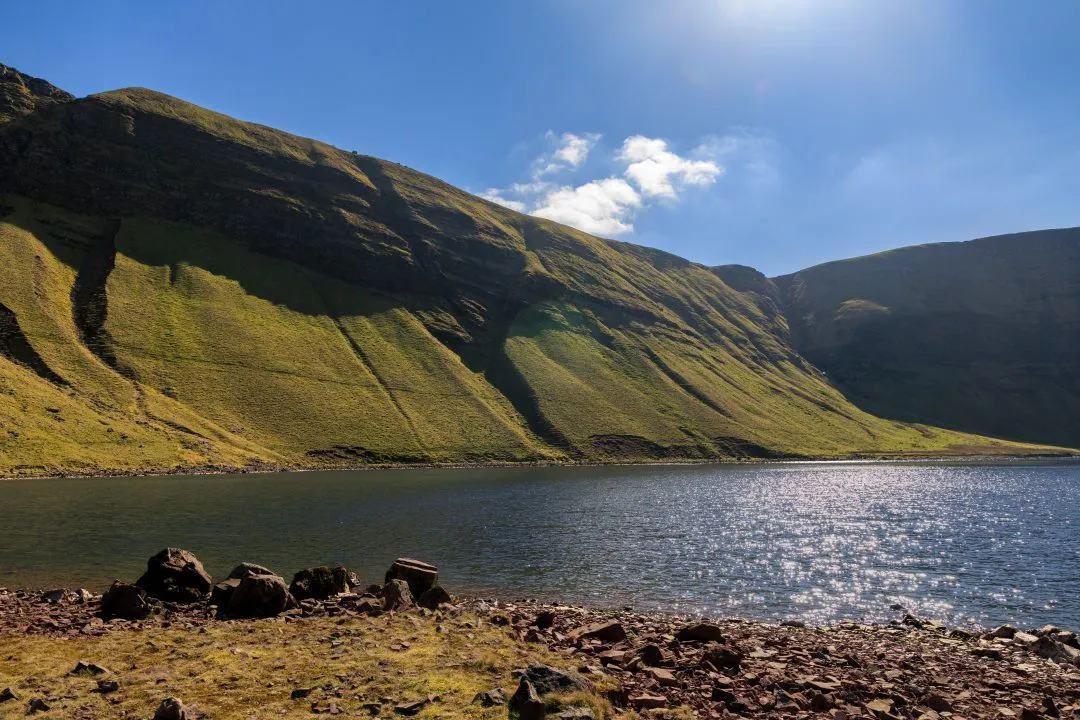 Mountain tarn escarpment reflection, the Brecon Beacons, Wales