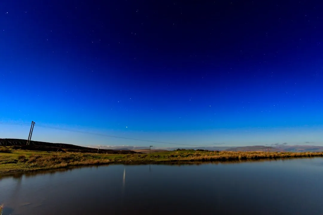 Starry sky reservoir astrophotography, the Brecon Beacons, Wales