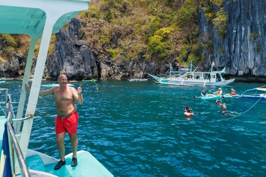 Candid playful passenger snorkelers boats El Nido