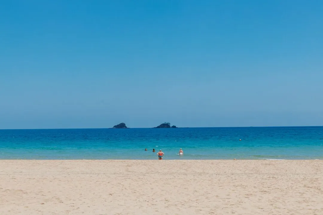 Clean turquoise beach rock islets El Nido