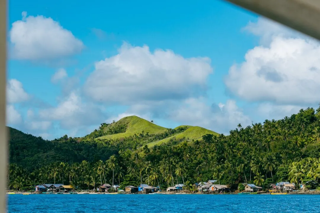 Coastal village green hills boat view siargao