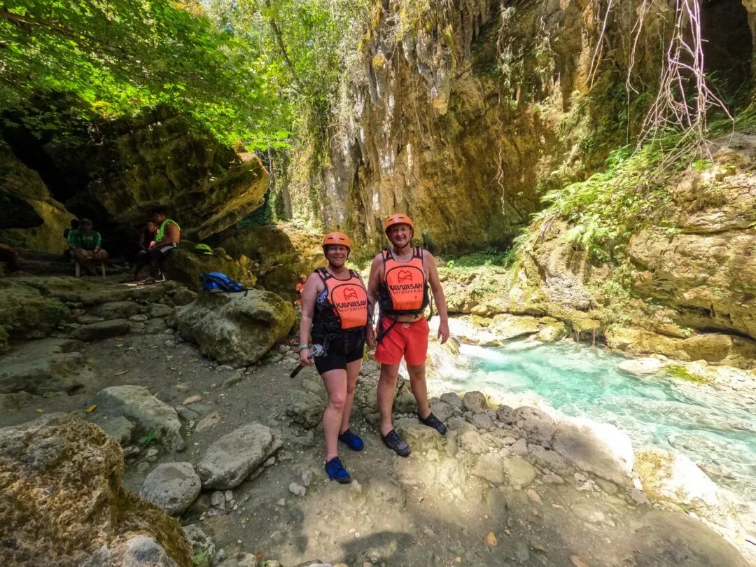 Couple embrace falling water droplets cave cebu