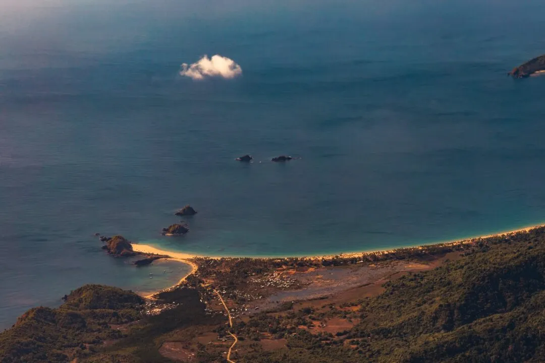 Descent aerial beach village cove El Nido