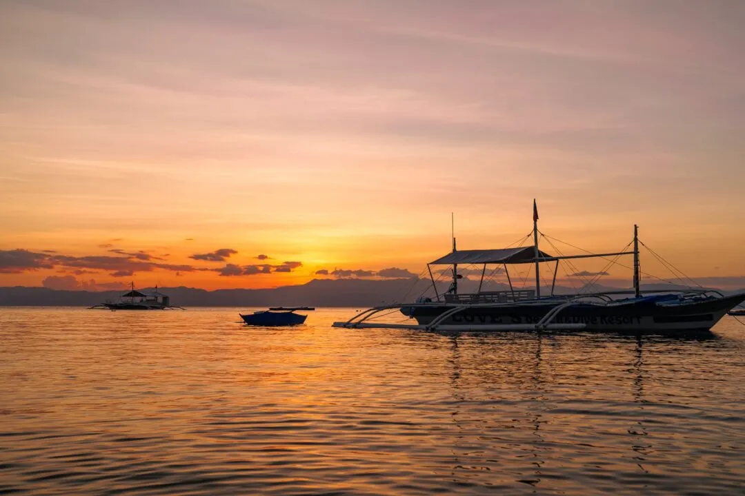 Dramatic pink orange clouds moored boat cebu