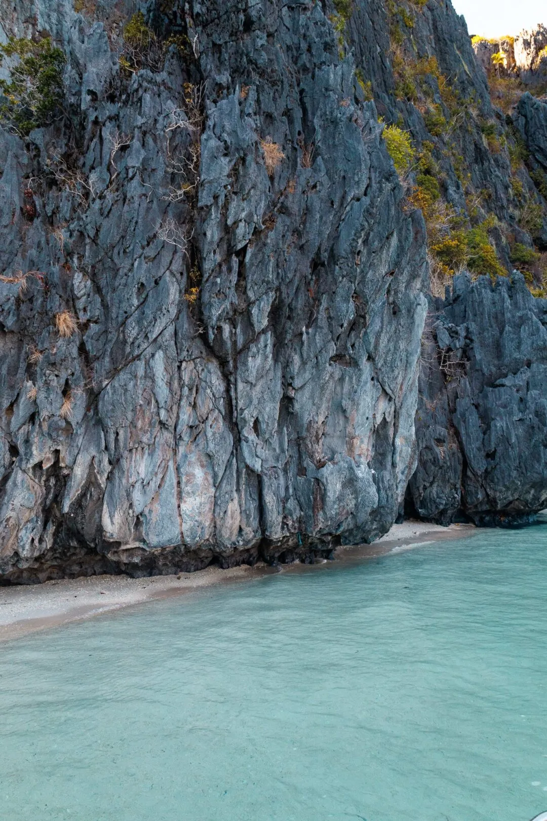 Dramatic vertical sheer karst wall water El Nido