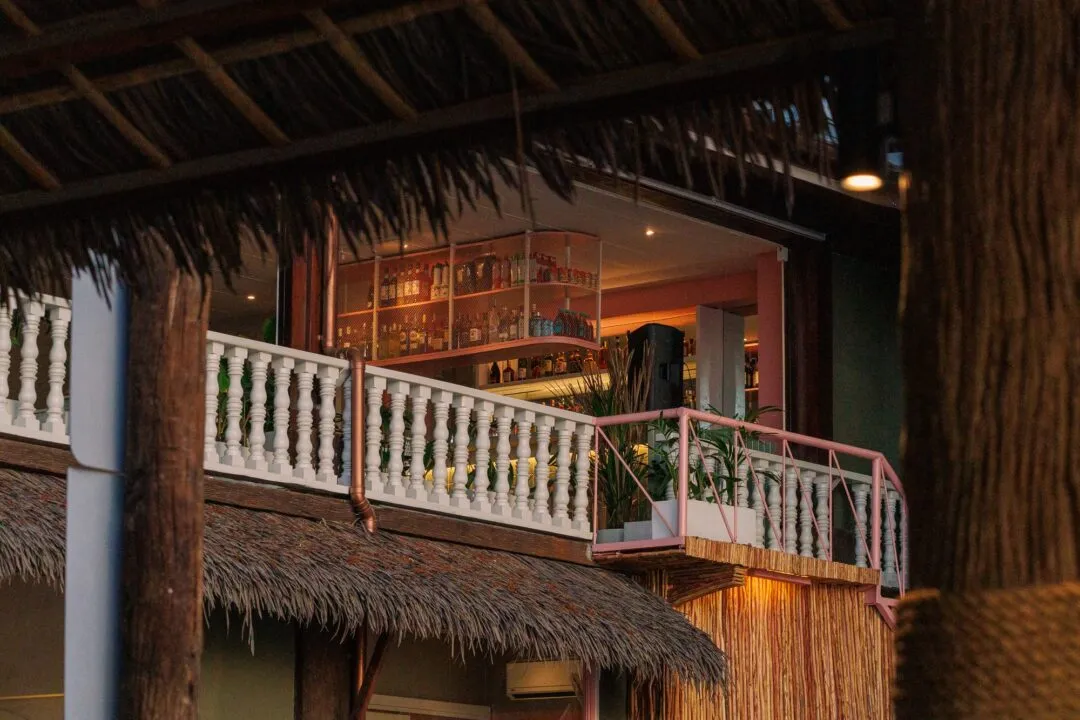 Dusk island bar balcony warm light El Nido