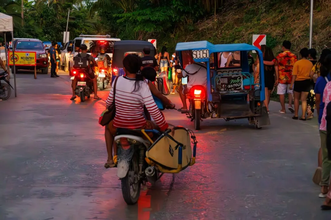 Dusk street scene motorbikes surfboard siargao