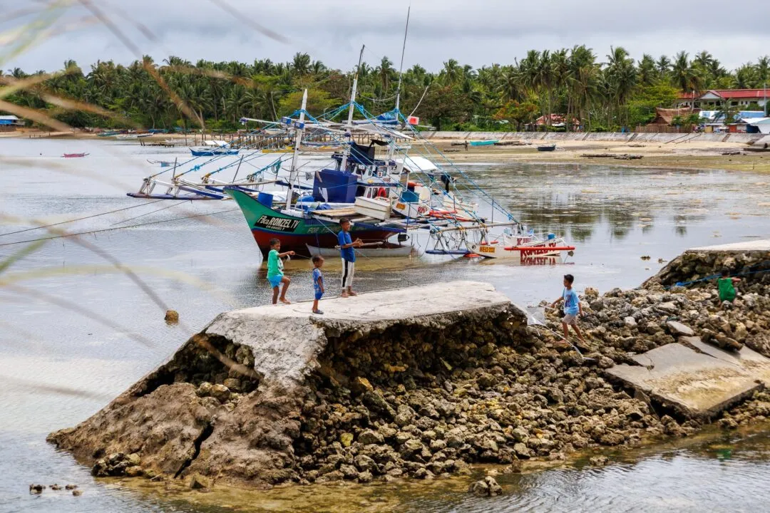 Fishing boats kids playing rocks siargao