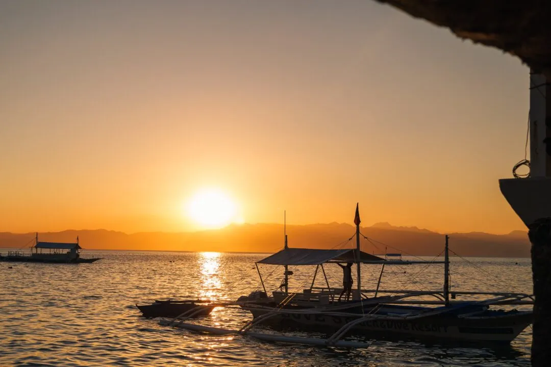 Glowing sunburst boat horizon cebu