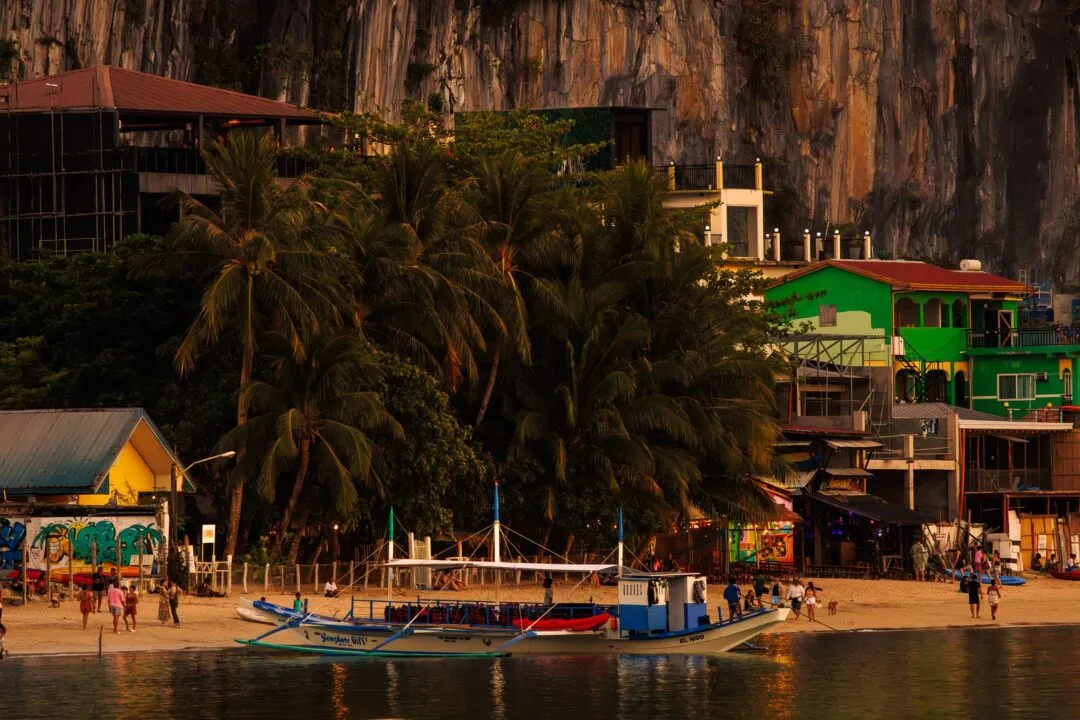 Golden hour town harbour green building cliff El Nido