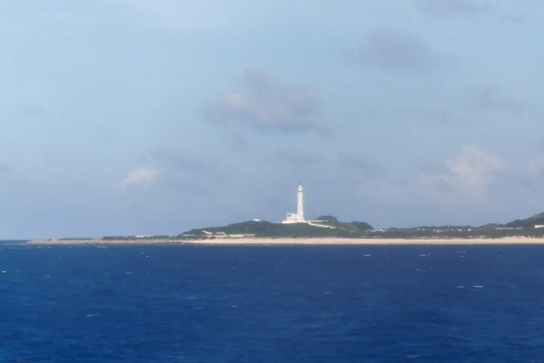 Lighthouse on a green cliff over turquoise water, Green Island, Taiwan