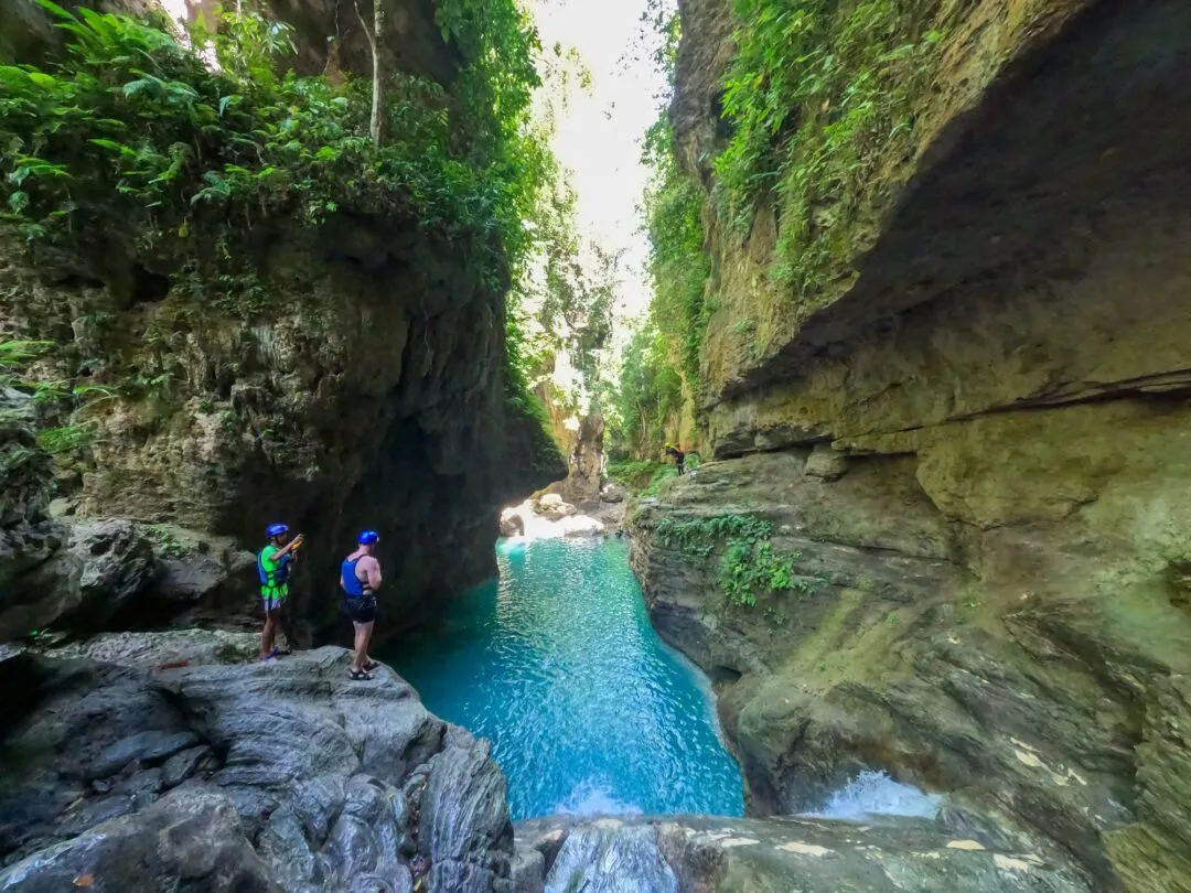 Guides overlooking turquoise plunge pool cebu