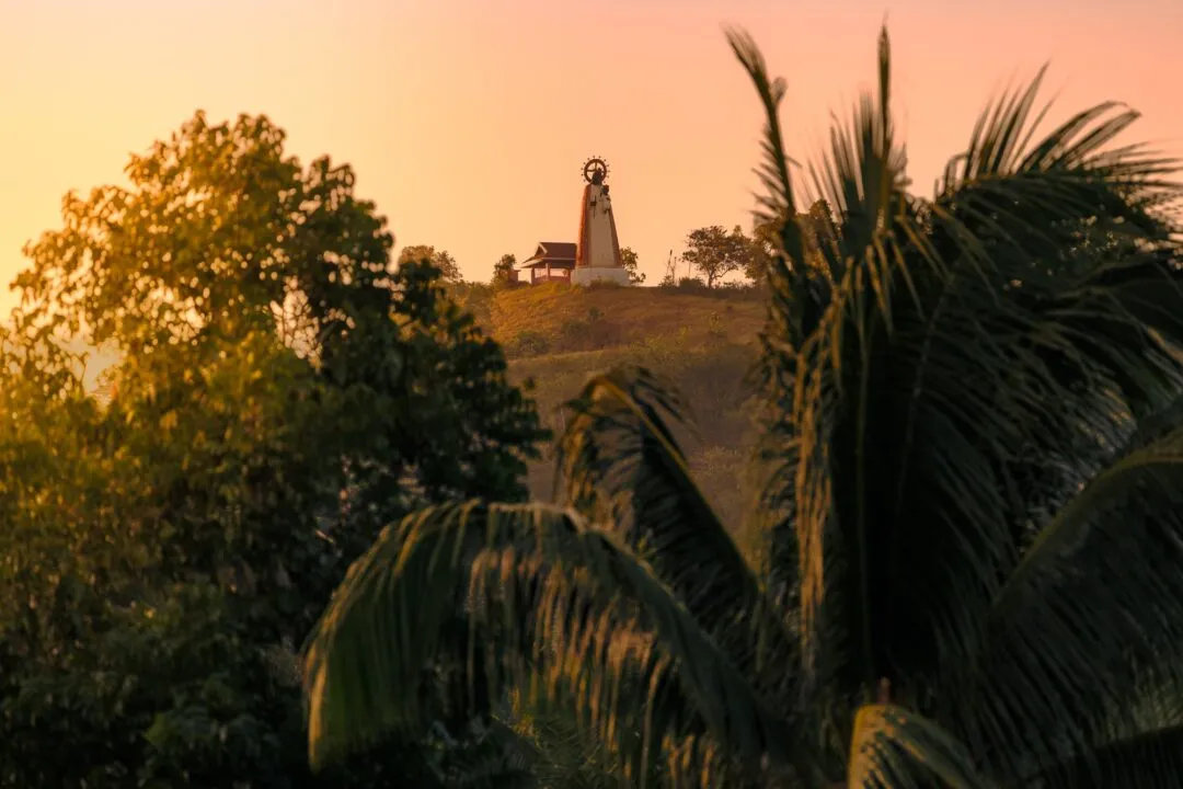 Hilltop shrine palm fronds golden hour bohol