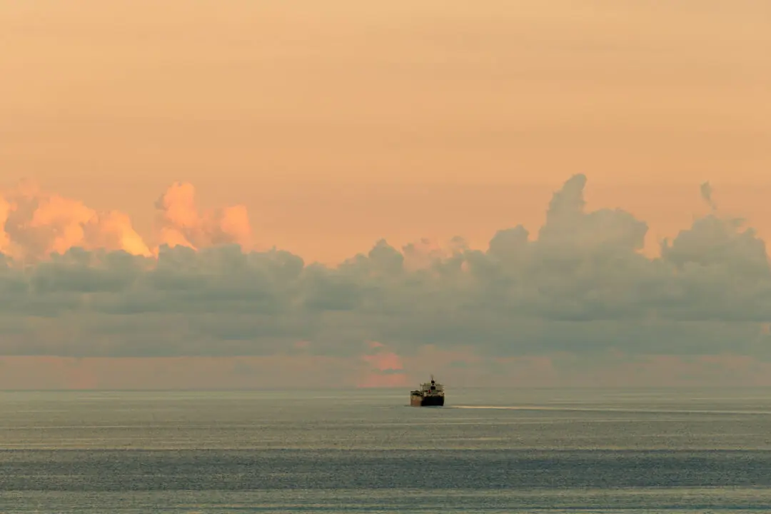 Ship silhouette against a saturated orange sunset over Hualien harbour, Taiwan