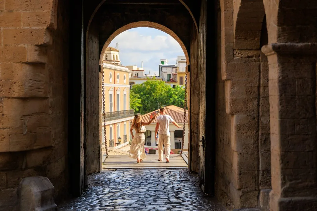 Gate archway couple walking, Ibiza Old Town