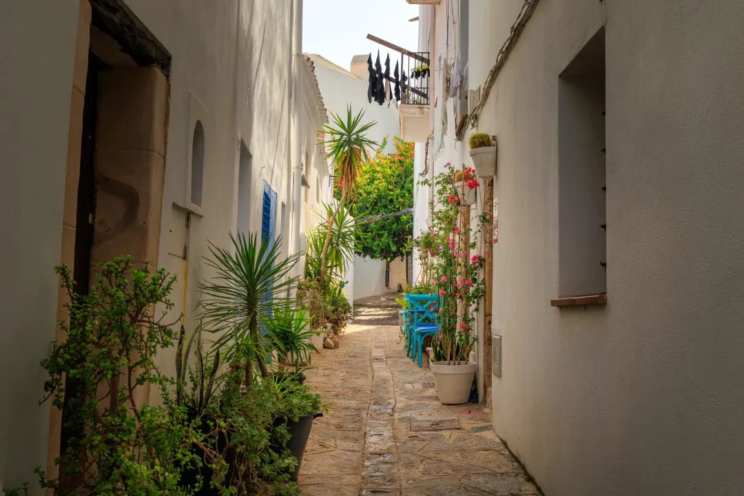 Narrow alley blue chairs flowers, Ibiza Old Town