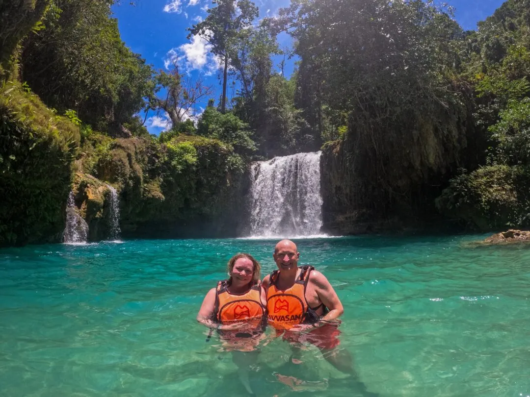 Iconic couple portrait twin waterfall turquoise pool cebu