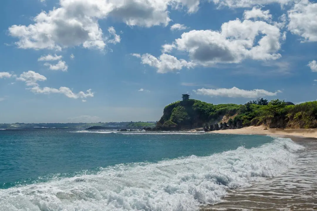 Dramatic headland with a watchtower under storm clouds and crashing waves, Kenting, Taiwan