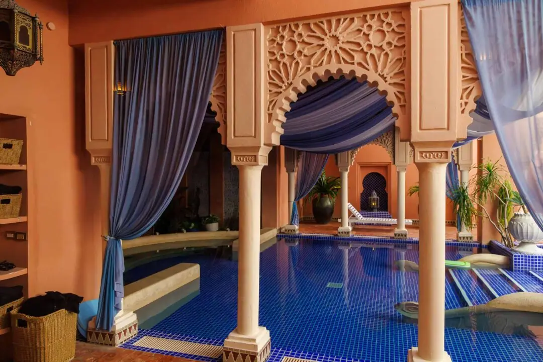 Moroccan-style resort pool archway with a draped blue curtain and terracotta walls, Kenting, Taiwan