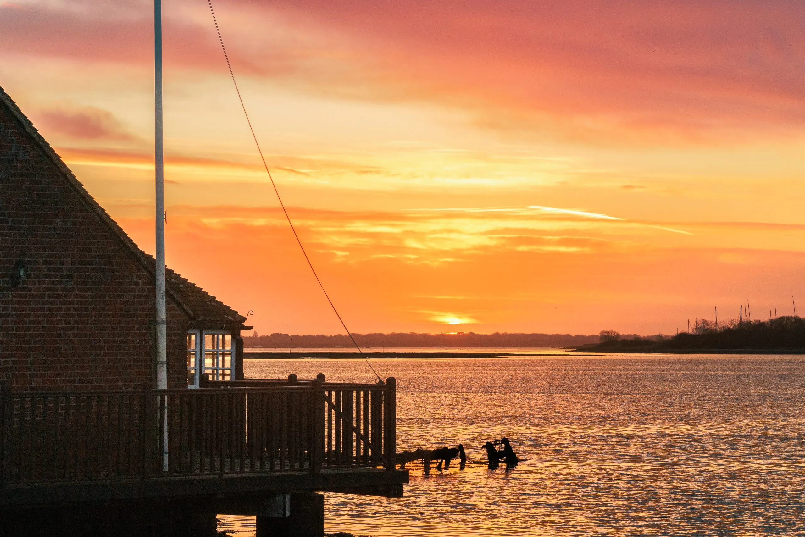 Langstone harbour boathouse silhouette sunset