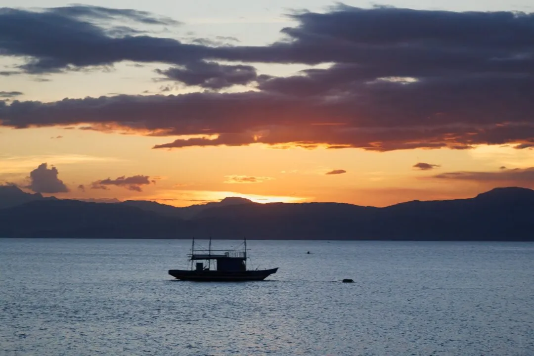 Minimalist fishing boat silhouette clouds cebu