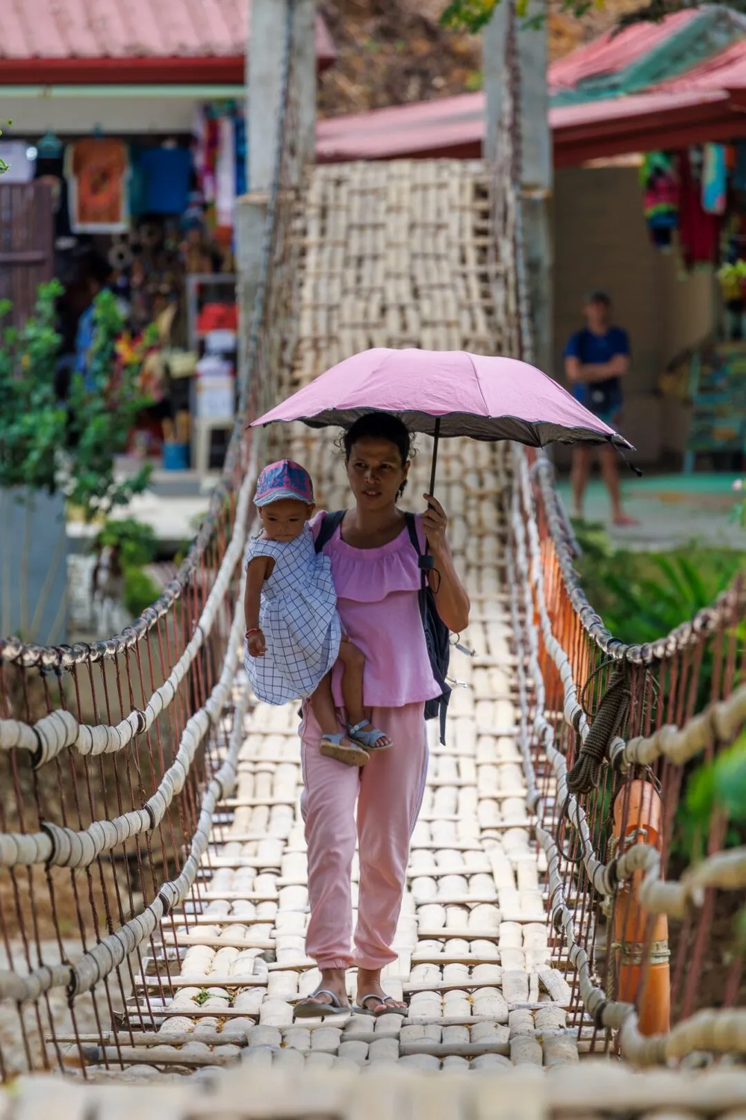 Mother child crossing bridge bohol