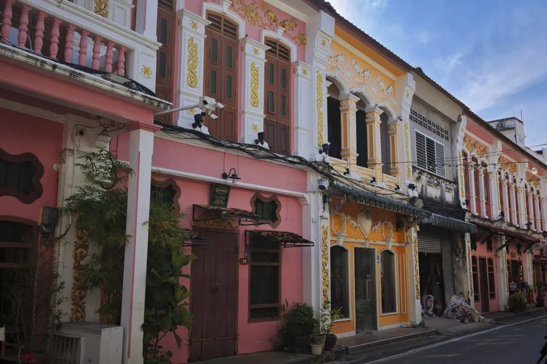 A street of pastel-coloured Sino-Portuguese shophouses in Phuket Old Town, Thailand.