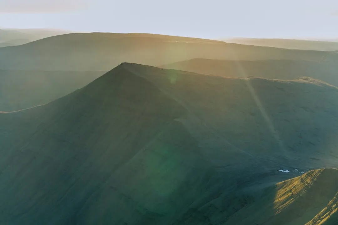 Pen y Fan mountain silhouette sunstar