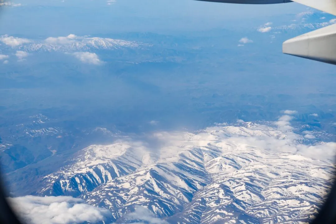 Plane window snow capped mountains manila
