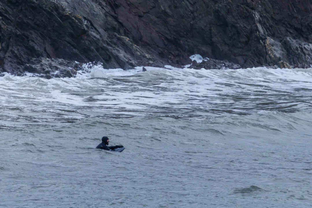 Bodyboarder waiting for waves, Wembury, Devon