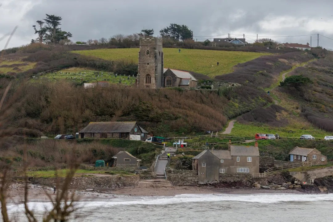 Wembury church tower above the village and cove, Wembury, Devon
