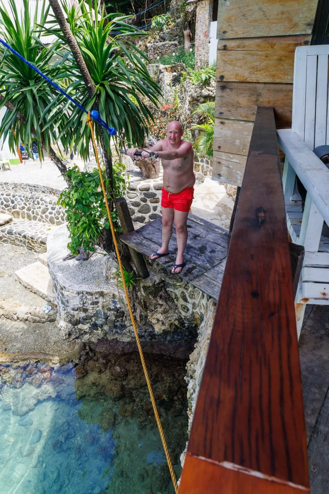 Rope swing cliffside pool siargao